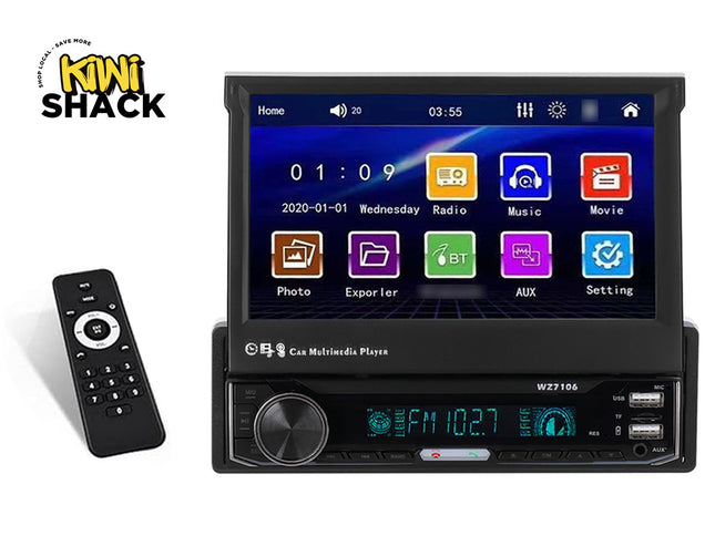 A black single-DIN car stereo multimedia player featuring a motorized pop-up touchscreen display, a digital radio receiver unit with a volume knob and dual USB ports, and a handheld remote control against a white background, featuring the "Kiwi Shack" logo in the upper left corner.