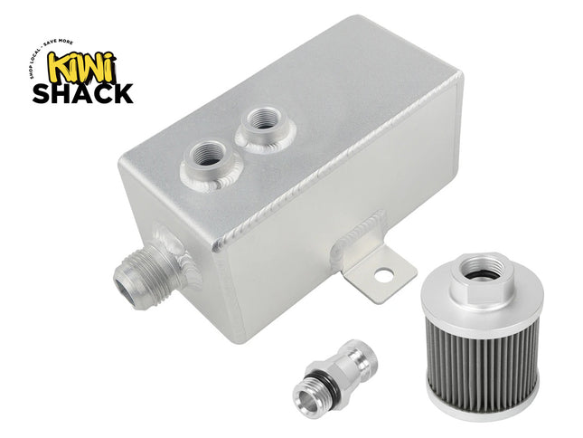 An aluminum engine oil reservoir tank with two threaded ports, a mounting bracket, a small metal fitting, and a cylindrical filter, shown on a white background with the Kiwi Shack logo in the top-left corner.