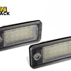 Two rectangular LED license plate lights with clear textured lenses and black housings, featuring the "Kiwi Shack" logo in the top-left corner.