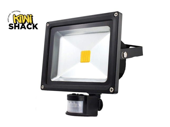 Black flood light with motion sensor on a white background, branded as Kiwi Shack.