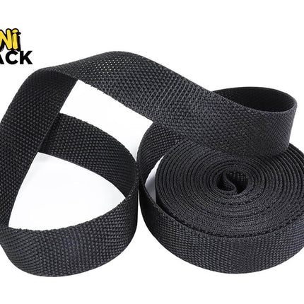 A roll of black woven webbing strap, partially unrolled to show its texture, on a white background with the Kiwi Shack logo in the top-left corner.