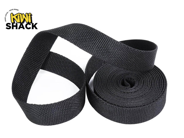 A roll of black woven webbing strap, partially unrolled to show its texture, on a white background with the Kiwi Shack logo in the top-left corner.