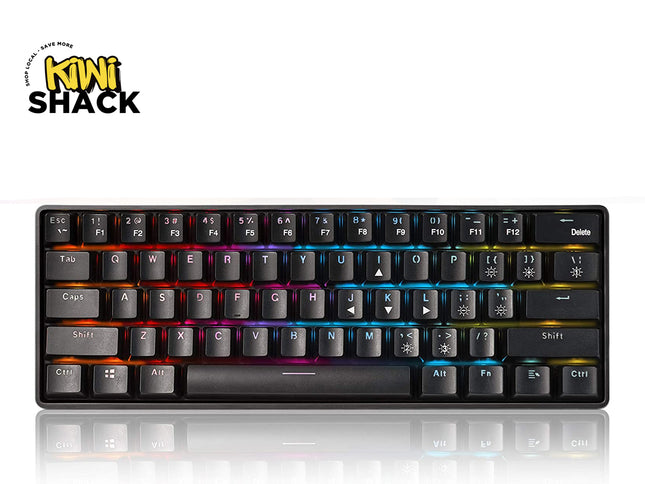 A black mini mechanical keyboard with RGB rainbow backlighting, shown from a top-down angle on a white background with a reflection below. The 'Kini Shack' brand logo is visible in the top-left corner.