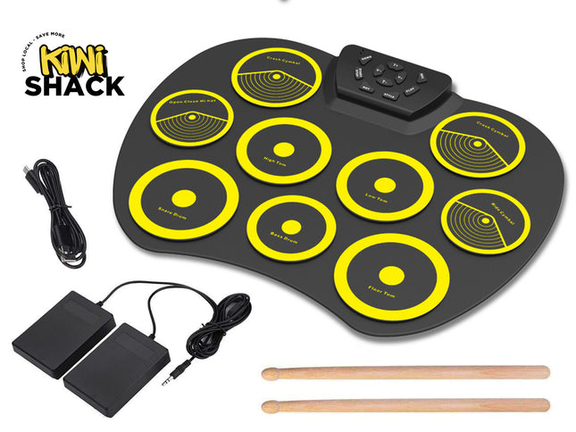 Electronic drum pad with yellow circles, foot pedals, and drumsticks on a white background, featuring Kiwi Shack branding.
