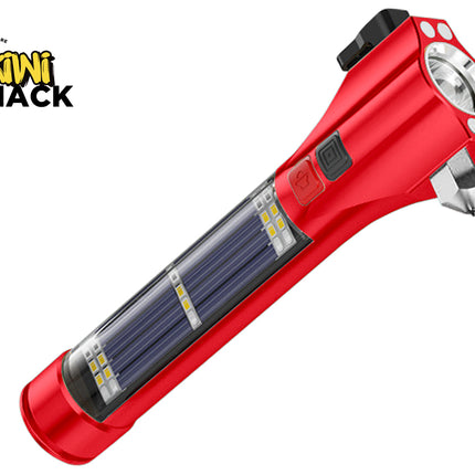 A red multi-function emergency safety flashlight featuring a built-in solar panel, side utility LEDs, a glass breaker hammer tip, and control buttons against a white background, featuring the "Kiwi Shack" logo in the upper left corner.