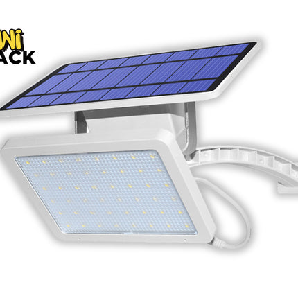A white solar-powered LED floodlight attached to a curved mounting arm, featuring a rectangular light panel and a separate solar panel mounted on top against a white background, featuring the "Kiwi Shack" logo in the upper left corner.