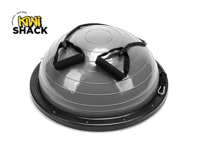 A gray and black semi-balastic dome exercise ball with foam handles on top, shown on a white background with the Kiwi Shack logo in the top-left corner.
