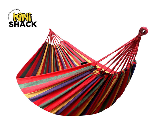 A colorful striped fabric hammock with reinforced woven hanging loops and suspension cords, featuring a "Kiwi Shack" logo in the top left corner.