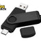 Black dual-interface USB flash drive / OTG thumb drive featuring a USB-A plug at one end, a USB-C plug at the opposite end with a protective cap lying nearby, a rotating/swiveling black metallic U-bracket clip, and the Kiwi Shack logo watermark.