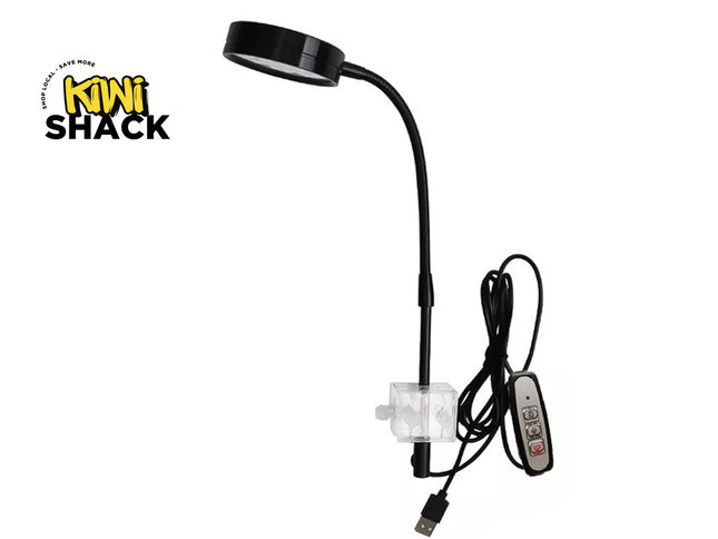 Black adjustable reading lamp with USB cable on a white background, featuring the Kiwi Shack logo.