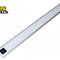 A slim, silver-rimmed LED under-cabinet light bar with a frosted diffuser panel and a motion sensor control module on one end against a white background, featuring the "Kiwi Shack" logo in the upper left corner.