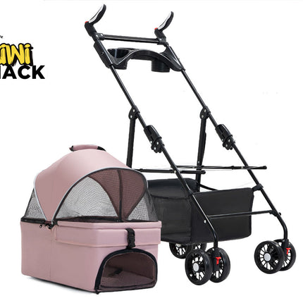 Pink and grey detachable pet carrier / bassinet with a mesh canopy and lower zipped mesh door, placed beside a black collapsible stroller frame with multi-wheel casters, a lower storage basket, and the Kiwi Shack logo watermark.