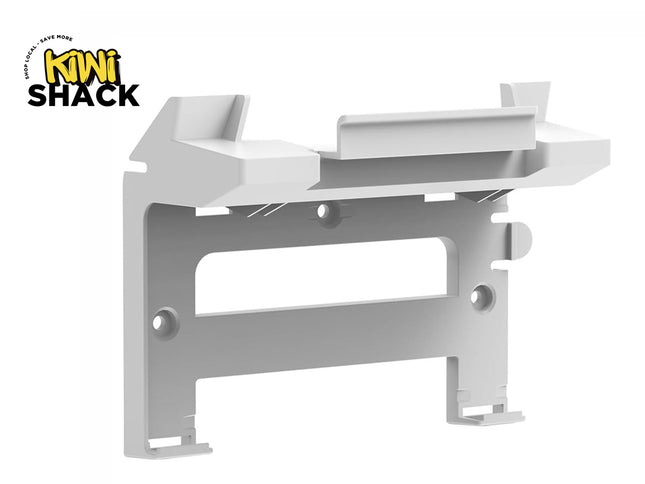 White plastic wall-mounting bracket/dock with countersunk screw holes and upper ledge cradle support, featuring Kiwi Shack logo in top left.
