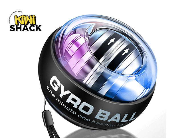 A Kiwi Shack Gyro Ball wrist exerciser shown on a white background. The product features a black outer shell with 'GYRO BALL' printed in white, a clear top dome showing a metallic silver inner ring with directional arrows, and a purple-to-blue iridescent gradient.