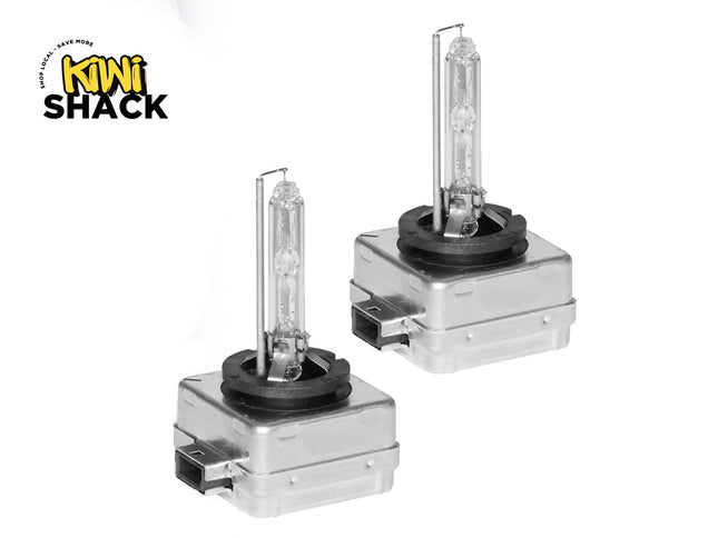 Two car headlights with a Kiwi Shack logo on a white background