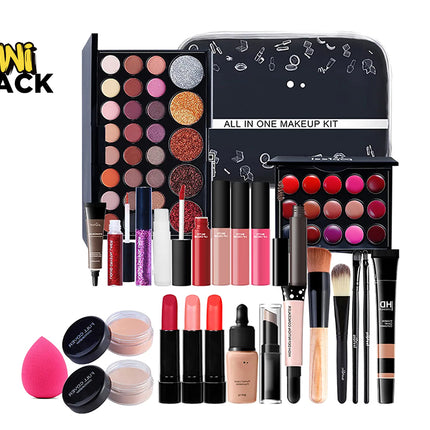 All-in-one makeup kit set featuring an eyeshadow palette, lip gloss/lipstick palette, zipped cosmetic case patterned with makeup icons, multiple lip gloss/liquid lipstick tubes, foundation/concealer tubes, application brushes, a pink teardrop blending sponge, face powder compacts, and the Kiwi Shack logo watermark.