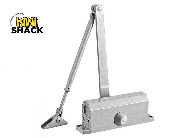 Metal door closer on a white background with 'Kiwi Shack' branding.