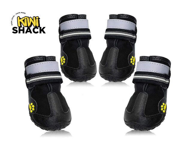 Set of four black dog boots with rubber toe caps, dual reflective/striped Velcro strap closures, yellow paw print accent graphics on the side, textured anti-slip soles, and Kiwi Shack logo watermark.