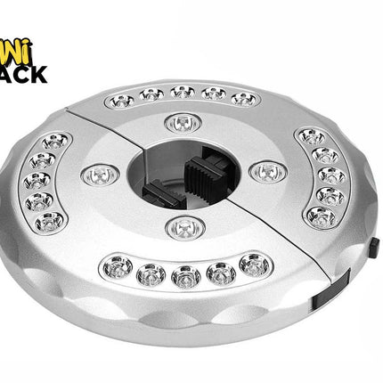 A silver circular patio umbrella LED light fixture with multiple embedded LED bulbs and a center clamp mechanism, featuring a "Kiwi Shack" logo in the top left corner.