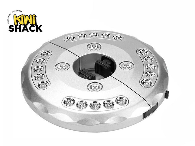 A silver circular patio umbrella LED light fixture with multiple embedded LED bulbs and a center clamp mechanism, featuring a "Kiwi Shack" logo in the top left corner.