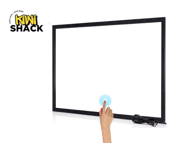 A black-framed touch screen whiteboard on a white background, with a hand touching the screen and the Kiwi Shack logo in the top left corner.