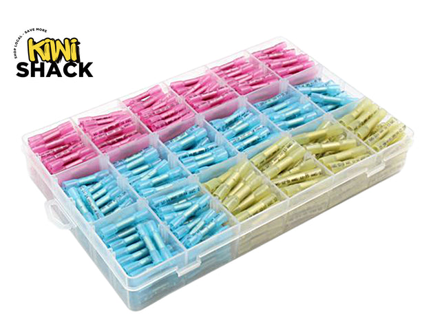A clear plastic storage organizer tray filled with small individually wrapped fishing line or thread spools in pink, light blue, and pale yellow-green. The Kiwi Shack logo is visible in the top-left corner on a plain white background.