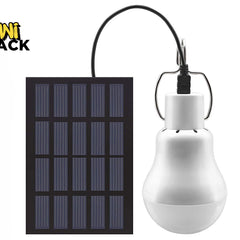 A portable solar-powered LED bulb connected by a black cord to a rectangular solar panel against a white background, featuring the "Kiwi Shack" logo in the upper left corner.