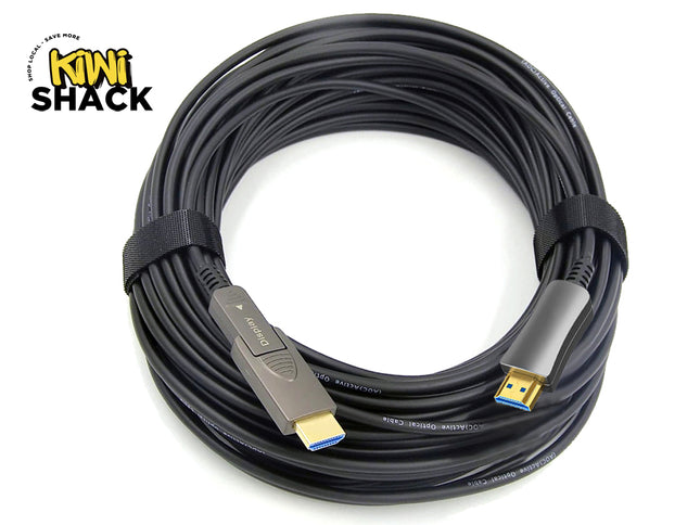 A coiled black HDMI cable with USB-C connectors on both ends, secured with a black elastic band, shown on a white background with the KINI SHACK logo in the top-left corner.