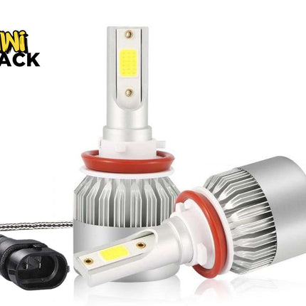 pair of LED automotive headlights with silver metal cooling heat sinks, red O-ring seals, and a connected power plug cable, set against a white background with the "Kiwi Shack" logo in the top left corner.