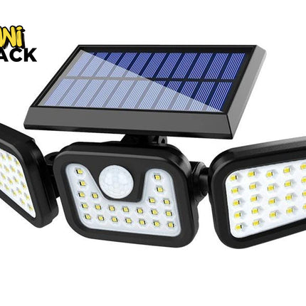 A three-light solar-powered outdoor floodlight with a central motion sensor, featuring a black housing, three adjustable LED lamp heads, and a blue solar panel on top. The Kiwi Shack logo is visible in the top left corner.