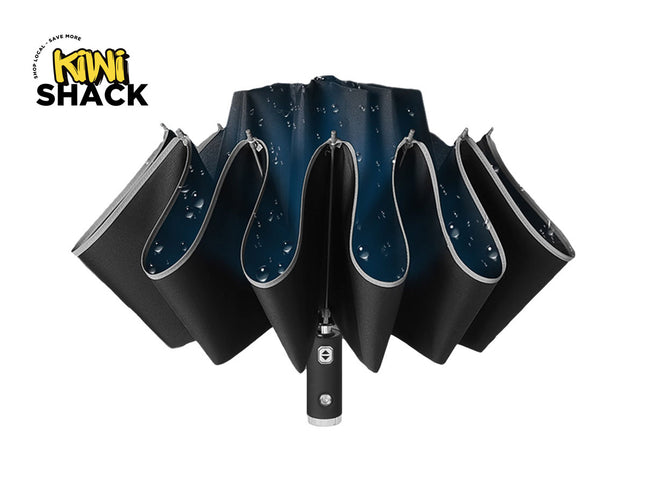 Black umbrella with reflective surface on a white background, branded with 'Kiwi Shack'.