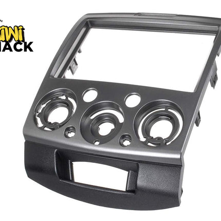 Metal dashboard panel with circular cutouts on a white background, featuring the Kiwi Shack logo.