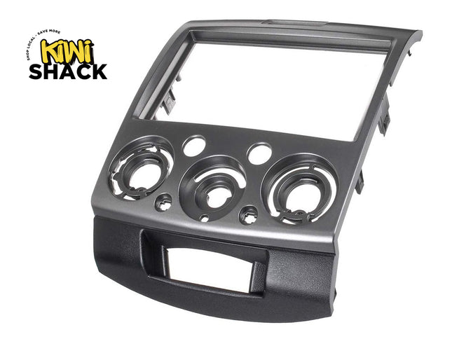 Metal dashboard panel with circular cutouts on a white background, featuring the Kiwi Shack logo.