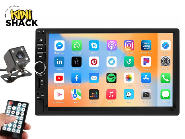 A double-din car stereo touchscreen head unit with app icons displayed, accompanied by a backup camera and remote control, featuring the "Kiwi Shack" logo in the top-left corner.