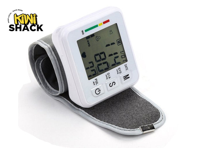 Wrist blood pressure monitor with digital display on a white background, branded 'Kiwi Shack'.