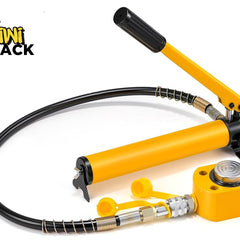 Yellow hydraulic hand pump connected via a spring-guarded black high-pressure hose to a compact yellow hydraulic cylinder jack with a silver piston cap, yellow protective dust caps, and Kiwi Shack logo in top left.