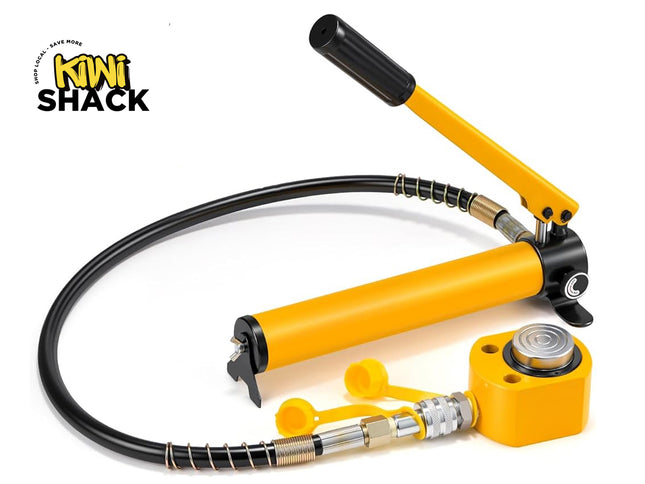 Yellow hydraulic hand pump connected via a spring-guarded black high-pressure hose to a compact yellow hydraulic cylinder jack with a silver piston cap, yellow protective dust caps, and Kiwi Shack logo in top left.