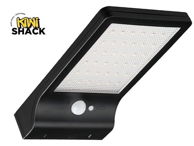 Black solar wall light with motion sensor on a white background, featuring the Kiwi Shack brand.