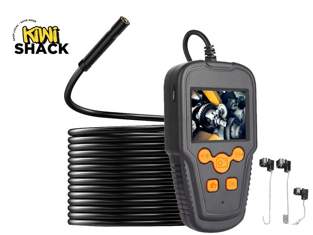 A mini endoscope camera with a flexible black probe, a handheld gray controller with orange buttons and a screen showing an internal engine view, a coiled black cable, and two small accessories on a white background. The 'Kini Shack' logo is visible in the top-left corner.