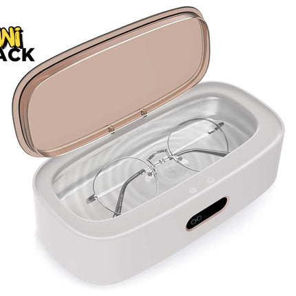 A white and rose gold portable UV glasses cleaner with its lid open, showing a pair of round-frame glasses inside. The KINI SHACK logo is visible in the top-left corner.