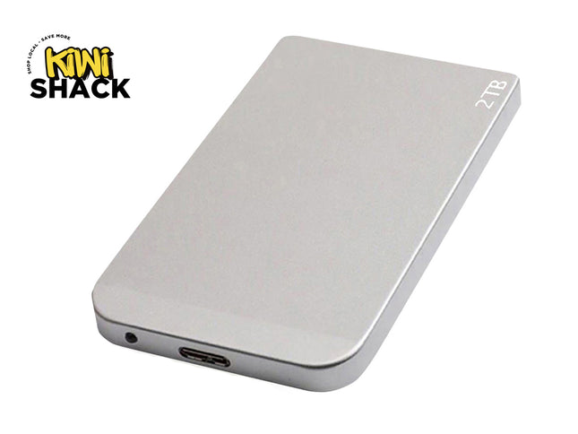 A sleek, silver 2TB portable external hard drive featuring a USB-C port and a status indicator light on the end against a white background, featuring the "Kiwi Shack" logo in the upper left corner.