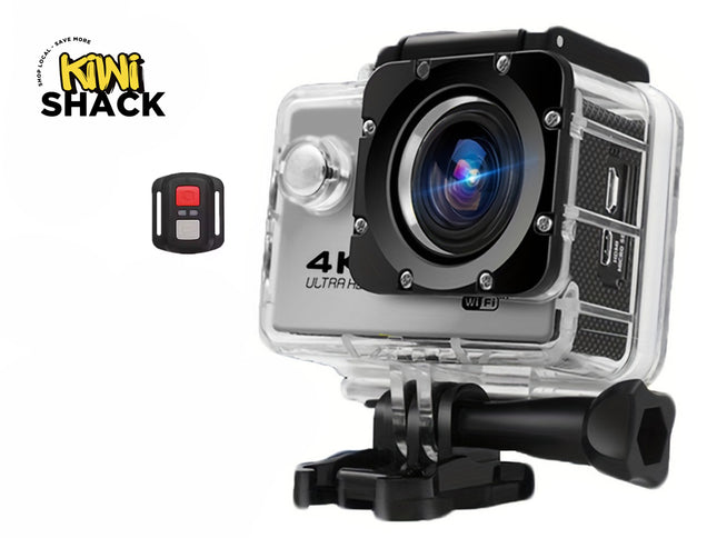 A 4K Ultra HD action camera enclosed in a clear waterproof housing with a mounting bracket attached to the base, accompanied by a small wireless remote control against a white background, featuring the "Kiwi Shack" logo in the upper left corner.