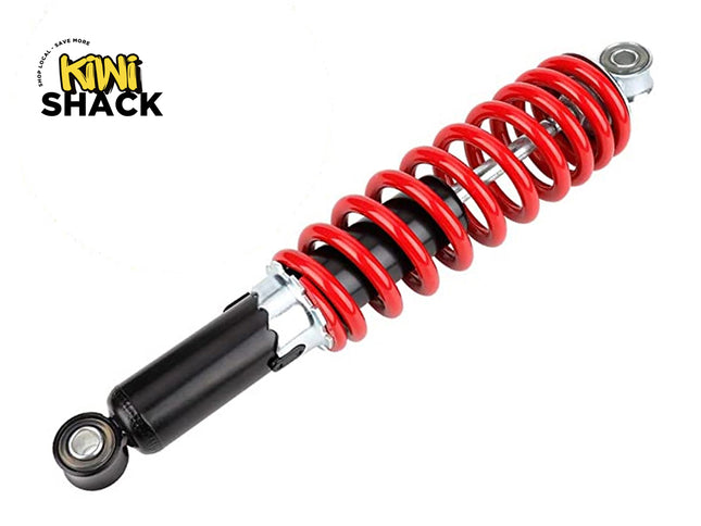 A heavy-duty motorcycle or ATV shock absorber with a bright red coil spring and black damping body, featuring the "Kiwi Shack" logo in the top-left corner.