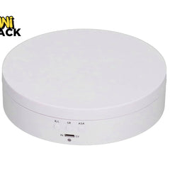 A white motorized rotating display stand featuring control buttons and a USB port on the front, set against a plain background with the "Kiwi Shack" logo in the top left corner.