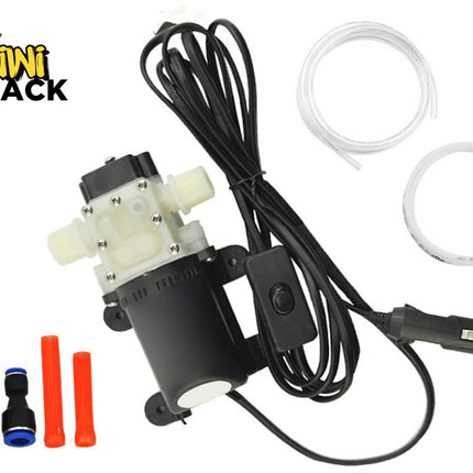 A 12V portable electric mini diaphragm water pump kit with power cord, cigarette lighter plug, tubes, and connectors, featuring the "Kiwi Shack" logo in the top-left corner.