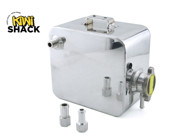 A shiny silver metal fuel tank or fuel cell component with several attached pipes and fittings, shown on a white background with the Kiwi Shack logo in the top-left corner. Two small metal fittings are placed in front of the main unit.