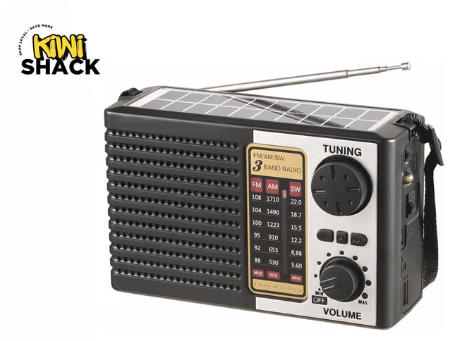 Kiwi Shack 3-band emergency solar radio with tuning dial, volume knob, speaker grille, and carrying strap.