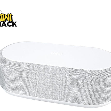 A modern white oval-shaped bedside smart speaker wrapped in textured gray acoustic fabric, featuring a wireless charging pad surface on top and a "Kiwi Shack" logo in the top left corner.