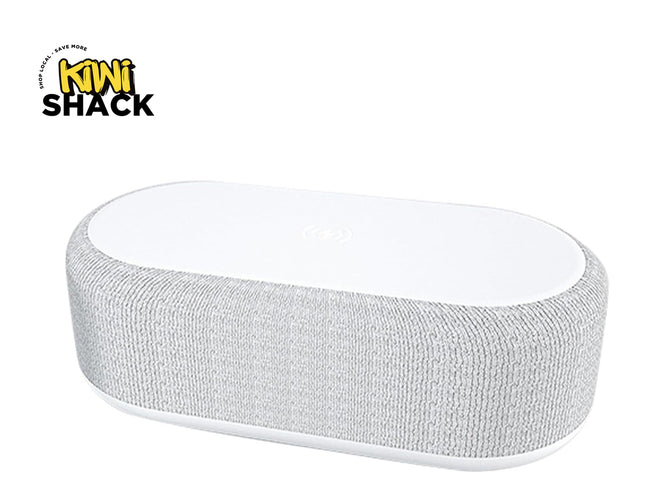 A modern white oval-shaped bedside smart speaker wrapped in textured gray acoustic fabric, featuring a wireless charging pad surface on top and a "Kiwi Shack" logo in the top left corner.