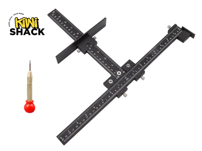 A black metal caliper-style measuring tool with engraved measurement markings, shown on a white background. A small screwdriver with a red handle is pictured to the left, and the Kiwi Shack logo appears in the upper left corner.